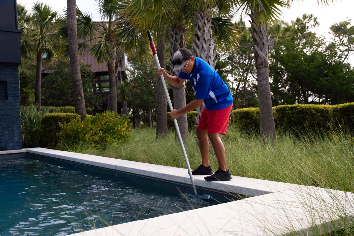 Pool technician brushing a pool on Isle of Palms, SC