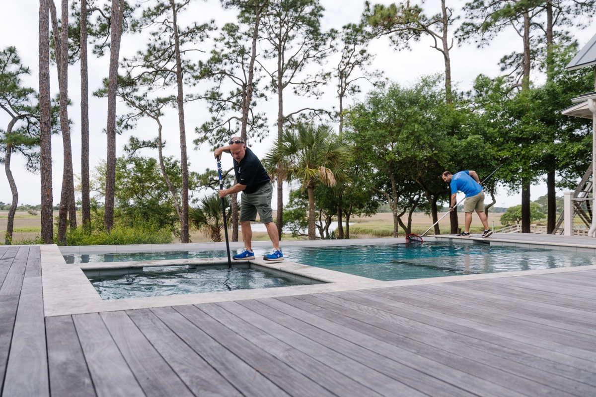 Two technicians cleaning a pool on Seabrook Island, SC